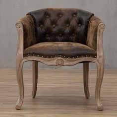 an old chair with leather upholstered on the back