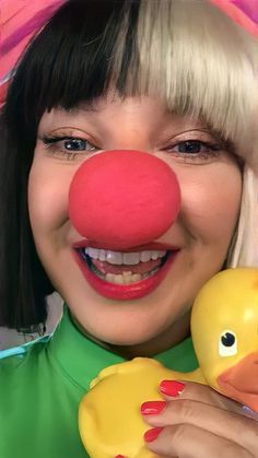 a woman with blonde hair holding a rubber ducky