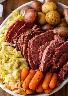 corned beef, cabbage, carrots and potatoes on a plate