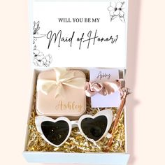 a gift box with two heart - shaped sunglasses and a note that says, will you be my maid of honor?