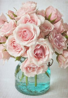 a vase filled with pink flowers on top of a table