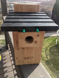 a bird house built on top of a deck