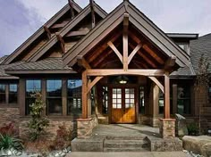 the front entrance to a large house with stone steps leading up to it's entry