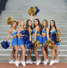 a group of cheerleaders standing in front of some stairs