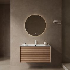 a bathroom with a round mirror above the sink