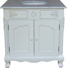 a white bathroom vanity with marble top and sink