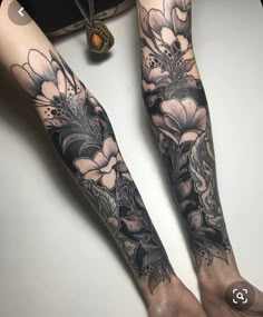 two women with tattoos on their arms and legs, both have flowers in the middle