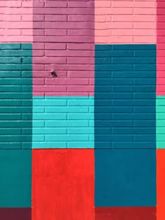 a colorful brick wall painted in different colors