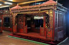 an elaborately decorated room with red and gold furniture