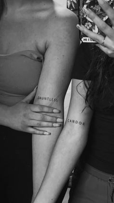 two women standing next to each other with tattoos on their arms and the words candor