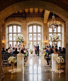 a bride and groom are walking down the aisle