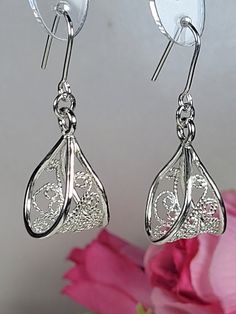 Filigree earrings made by intricate metal work, creating a rich floral and dainty look. The art nouveau earrings are inspired by Art nouveau jewelry combined with modern design. These floral dangle earrings are perfect for a beloved woman, and as a pampering gift for yourself. The earrings are very flattering, comfortable to wear as a jewel for everyday use and impressive as a jewel for a special occasion. The structure of the earrings is approximately 20 mm long, creating an elegant and unique style. The earrings are made of 925 sterling silver by hand tools only. Each piece of jewelry is handmade to order, therefor due to the special nature of handcrafting, there may be slight differences compared to the jewelry in the photos shown. This adds to the charm and individuality of each piece, Ornate Sterling Silver Earrings With Elegant Design, Ornate Drop Earrings For Gifts, Filigree Drop Jewelry For Gifts, Ornate Drop Earrings Gift, Filigree Drop Jewelry As Gift, Exquisite Filigree Earrings For Gift, Filigree Drop Earrings As A Gift, Ornate Drop Earrings With Elegant Design, Sterling Silver Filigree Chandelier Earrings For Formal Events