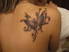 a woman with a butterfly tattoo on her back