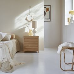 a bedroom with white walls and furniture in it