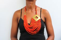 African beaded necklace, Beaded Fringe Necklace, Maasai Women Jewelry, Multi-strand necklace, Christmas gift, Mom's gift, one size fit all An elegant necklace that can complement any outfit. Handmade by the Maasai women in Kenya using fine beads. It has a brass metal decoration on the side. One size fit all. Color: Red and orange mixture Necklace length: 15 inches 3-5 days delivery via DHL Express.  Pay shipping fee for the first item only and additional items ship for FREE. To view more items i African Beads Necklace, Red Beaded Necklaces, Fringe Necklace, Maasai, African Beads, Beaded Fringe, Elegant Necklaces, Red Bead, Multi Strand Necklace