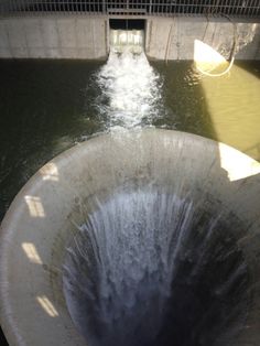 the water is coming out of the pipe into the river and it's discharge