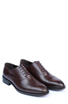 Handmade of smooth leather, this cap-toe dress shoe with a classic oxford silhouette offers a sophisticated, elegant look. Leather upper and lining/synthetic sole Made in Turkey Classic Oxford Lace-up Shoes With Rubber Heel Cap, Business Derby Oxford Shoes With Cap Toe, Fitted Oxfords With Rubber Heel Cap For Business, Business Oxfords With Rubber Heel Cap, Elegant Cap Toe Oxford For Semi-formal Occasions, Elegant Semi-formal Oxford Shoes With Cap Toe, Elegant Semi-formal Cap Toe Oxford Shoes, Elegant Semi-formal Cap Toe Oxford, Oxford Dress Shoes With Leather Lining And Cap Toe