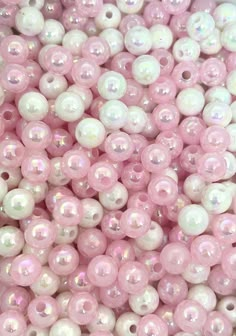 some pink and white beads are in a pile