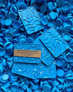 there are many blue cups that have been made into soap dishes and tags on them