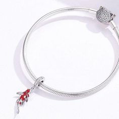 This is charm only, bracelet is sold separately. This beautiful fish pendant charm for Pandora style bracelet features red carp fish / Koi fish design dangle with cubic zirconia pave, made of solid 925 sterling silver and enamel color. Add this beautiful Koi fish dangle charm to your existing Pandora style bracelet or as gift for your love one. Jewelry Care: See more information about how to care for your jewelry here. Shipping Policy: Orders will be shipped within 1-3 business days. Economy shi Elegant Silver Charms With Lobster Clasp, Sterling Silver Jewelry With Removable Round Charms, Elegant Sterling Silver Charms With Removable Features, Elegant Sterling Silver Charms With Removable Details, Sterling Silver Charms With Removable Feature, Removable Sterling Silver Charms In Silver, Silver Sterling Silver Charms With Removable Feature, Gift Jewelry With Removable Charms On Snake Chain, Sterling Silver Charms With Lobster Clasp