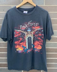 "Vintage 1990s Pink Floyd The Wall Tour T-shirt / Band Tee / Rock / Made in USA / 90s T-shirt  / Premium Vintage - Size L (Length 28\", Chest 20\") - Very rare find! - Overall great vintage condition (small hole on front stomach area/no stains) - Message for more information Please take note of the measurements listed as these are vintage clothes and may fit different than the tag size. Follow our page for more vintage clothing drops! Connect with us on Instagram: @recurarchives" 90s Band Logo T-shirt For Summer, 90s Style Band Logo T-shirt For Summer, 90s Band Logo T-shirt For Music Festivals, 90s Style Concert T-shirt With Screen Print, Vintage Graphic Design T-shirt For Music Festivals, 90s Band Logo Tops For Fan Merchandise, 90s Crew Neck T-shirt For Concerts, 90s Style Tops With Band Logo For Fans, 90s Style Pre-shrunk T-shirt For Concert