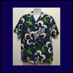 "Vintage 1960s bark cloth tiki hawaiian shirt by Evelyn Margolis hawaii. Size medium/large The bark cloth cotton shirt has an abstract bold floral/ tiki style design in shades of blues, lime green and white. The bark cloth cotton shirt has a pointed collar, five button down front, short sleeves and one patch pocket. Label states Evelyn Margolis hawaii The shirt is in vintage condition and sold as is. Please see pictures above showing small stains on front of shirt. MEASUREMENTS: (All measurement Fitted Hawaiian Shirt With Camp Collar, Green Hawaiian Shirt With Graphic Print, Fitted Hawaiian Camp Shirt For The Beach, Fitted Hawaiian Camp Shirt For Beach, Vintage Blue Hawaiian Shirt With Floral Print, Vintage Blue Floral Print Hawaiian Shirt, Fitted Hawaiian Shirt For Vacation, Vintage Green Camp Shirt For The Beach, Vintage Green Camp Shirt For Beach