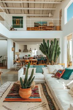 a living room filled with furniture and a large cactus in a pot on top of a rug