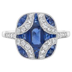 A gorgeous art deco fashion ring, featuring a 0.56 carat emerald cut blue sapphire, set on platinum. Surrounded by round brilliant cut diamonds weighing 0.29 carat total in a unique curved design that continue on to the shank in a half-way setting. Accented by more blue sapphires weighing 0.59 carat total. Finished with milgrain edges. Size 6.5 US, resizable upon request.  Available in a matching necklace and earrings. Please inquire about items DN1447 and DEAR1706. Roman Malakov is a custom hou Art Deco Style Fashion, Deco Fashion, Platinum Diamond Rings, Diamond Fashion Rings, Blue Sapphire Diamond, Marquise Cut Diamond, Modern Ring, Domed Ring, Platinum Ring