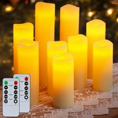 several candles with remote controls sitting on a table