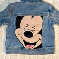 a denim jacket with an image of mickey mouse on it