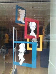 the reflection of two people in a window is seen on display at an art gallery