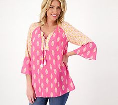 Wardrobe winner! This is the printed tunic to get you excited about your spring/summer closet. Get ready to reach for this tasseled tunic on the regular. From Susan Graver.