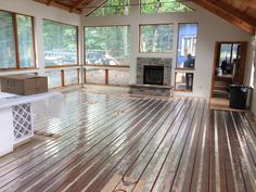 an empty room with wood flooring and windows in the ceiling is being painted white