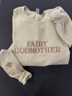 a white shirt with the words fairy godmother written on it and a pair of socks