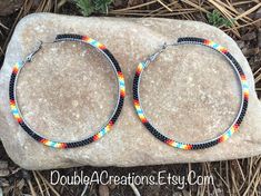 "Here's a pair of Black with Native Colors hoop earrings that are lightweight and comfortable to wear all day long. Made with high quality glass Delica Beads, beaded one bead at a time.  Love and passion goes into making my jewelry. This process requires focus, patience and dedication. Each bead is 16th of an inch and can take hours to complete a project. These hoops are 3\" wide around. They would be a great addition to your wardrobe.  You will receive many compliments. These hoops would be a g Wrapped Rope, Native Earrings, Beadwork Ideas, Native Beading, Colored Earrings, Country Jewelry, Beaded Earrings Tutorials, Seed Beading, Native American Beadwork