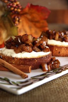 two pieces of bread topped with whipped cream and cinnamon sticks