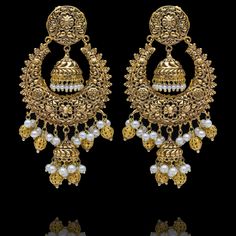 A fun pair with classic deign that never goes out-of-style! Gorgeous pair of earrings that is a perfect pick to pull-off any traditional or ethnic look. With its beautiful metal carving, embossed details and timeless jhumki design with an addition to pearl moti, this pair is all you need for the upcoming events. Kajal Earrings are available in two sizes. Big earrings are about 4.5" long and small earrings are about 3" long. Gold-plated on high-quality brass as base metal. Delivery time frame is Metal Chandbali Chandelier Earrings With Intricate Design, Traditional Metal Earrings For Festive Occasions, Traditional Festive Metal Earrings, Festive Bridal Earrings With Intricate Metal Design, Metal Chandbali Earrings With Filigree, Filigree Chandbali Earrings, Heavy Brass Drop Earrings, Festive Metal Pearl Earrings For Pierced Ears, Intricate Metal Chandbalis Drop Earrings