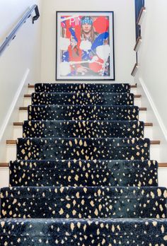 the stairs are decorated with black and gold spots on them, as well as a painting