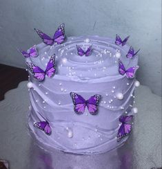 a purple cake with butterflies on it