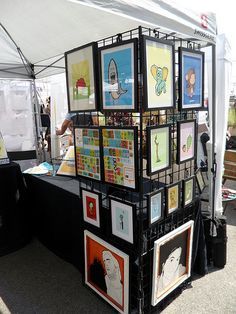 an outdoor art stand with pictures on it