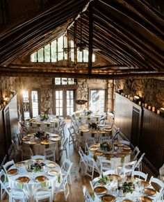 a room filled with lots of white tables and chairs