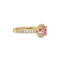 a yellow gold ring with an oval shaped pink diamond