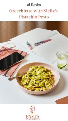 there is a bowl of food on the table with glasses and papers next to it