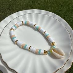 The serene sound of waves gently lapping against the shore, the warmth of the sun, and the cool breeze carrying the scent of salt and sand... This isn't just any bracelet; it's your personal piece of the beach, crafted with love and a dash of coastal charm. Ocean-inspired Beaded Bracelets For Beach, Beachy Beaded Bracelets For Beach Season Vacation, Beach Jewelry With White Letter Beads, White Strand Bracelets For Vacation, White Beach Jewelry With Letter Beads, White Strand Bracelet For Vacation, Bohemian Jewelry With Letter Beads For Beach Season, White Letter Beads Jewelry For Beach, Beachy Shell Friendship Bracelets For Beach