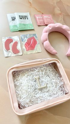 the contents of a pink and white cat earring laying on top of a table