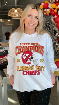 White Super Bowl Champions Sweatshirt - Our White Super Bowl Champions Sweatshirt is a white, crewneck style sweatshirt with red and golden lettering and a vintage vibe. It is the PERFECT way to show your love for our Chiefs all year long! - Pair with your favorite pants, a pair of our super popular Star Sneakers, and some of our super cute KC earrings! - Available in sizes small through 2XL White Screen Print Sweatshirt For Fan Gear, Game Day White Sweatshirt With Screen Print, White Sweatshirt With Game Day Screen Print, White Lettering Sweatshirt For Game Day, White Sweatshirt With Letter Print For Fans, White Lettering Sweatshirt For Sports Season, Super Bowl Champions, Crewneck Style, Style Sweatshirt