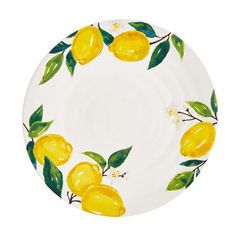 a white plate with yellow lemons and green leaves on the rim, against a white background