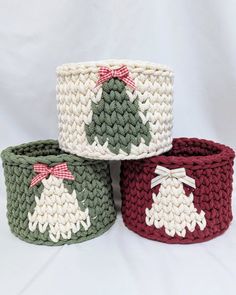 three crocheted baskets with christmas trees on them