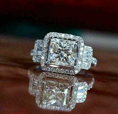 an engagement ring with three princess cut diamonds