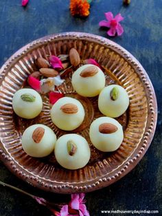 some kind of dessert on a plate with flowers around it and nuts in the middle